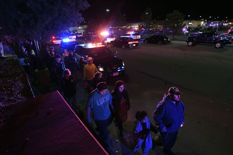 Employees and shoppers are released from a holding area in Walmart lot in Thornton on Nov. 1.