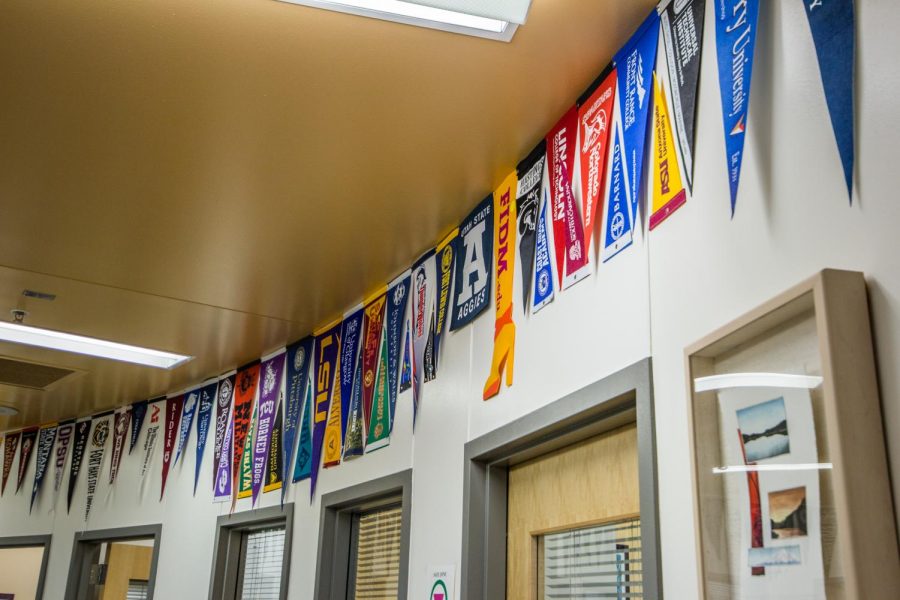  A string of banners representing various colleges lines the counseling office. 