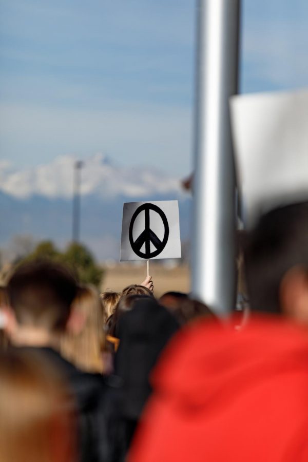 The peace sign, originally designed in 1958, is held up by a participant at Wednesdays event. 