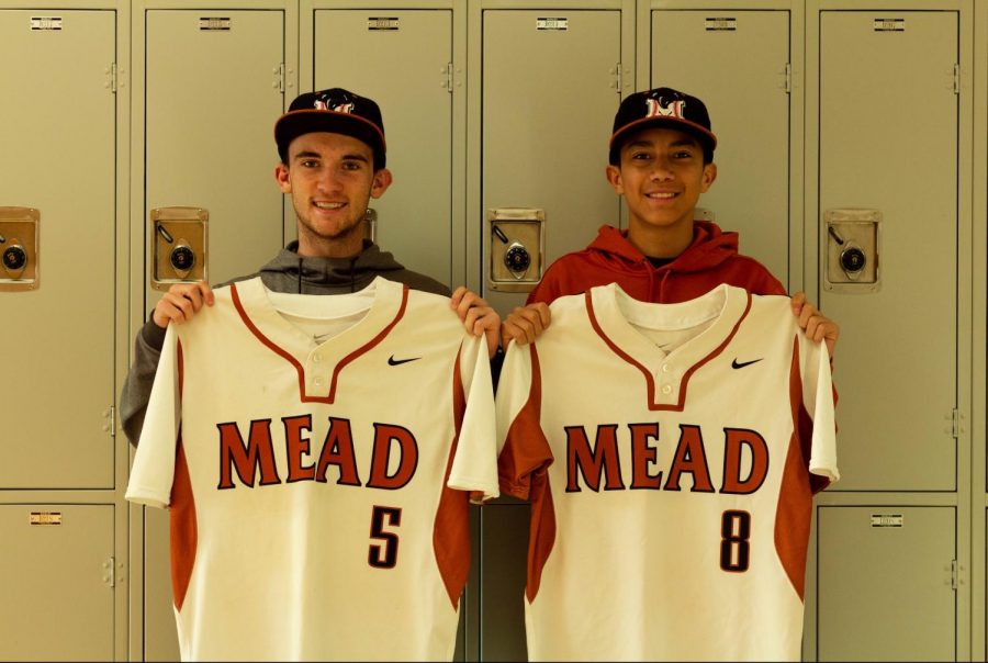 Players Jason  Torbeck and Jalen Martinez pose with their jerseys. 