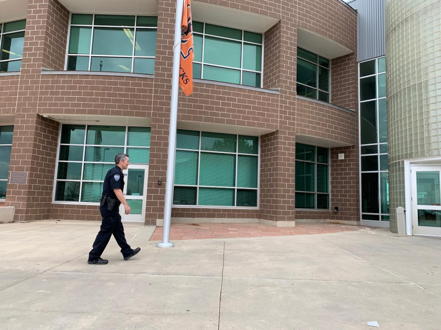 Chief of police Brent Newbanks walking into Mead High School