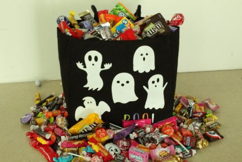 Candy overflows a Halloween bag. 