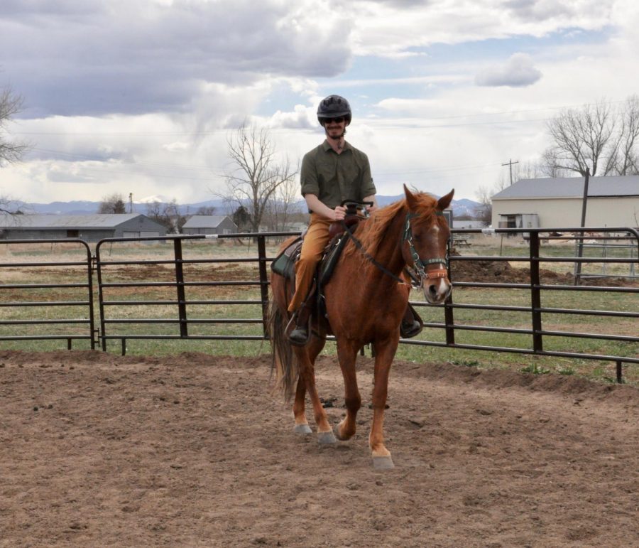 A Veteran riding a horse at the ranch. 