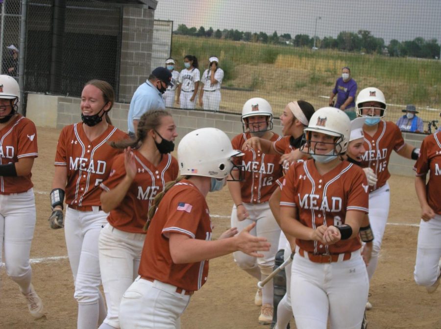 The softball girls celebrate Wiesecamps grand slam during their game vs Holy Family.