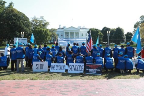 A picture taken by Kuzzat Altay depicts a group of people gathered on Pennsylvania Avenue in front of the White House in order to address and protest the Uighur genocide in China.
