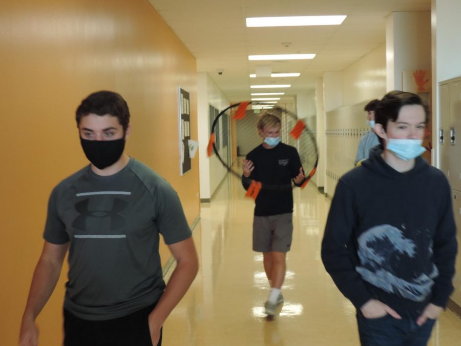 students in the hallway with masks