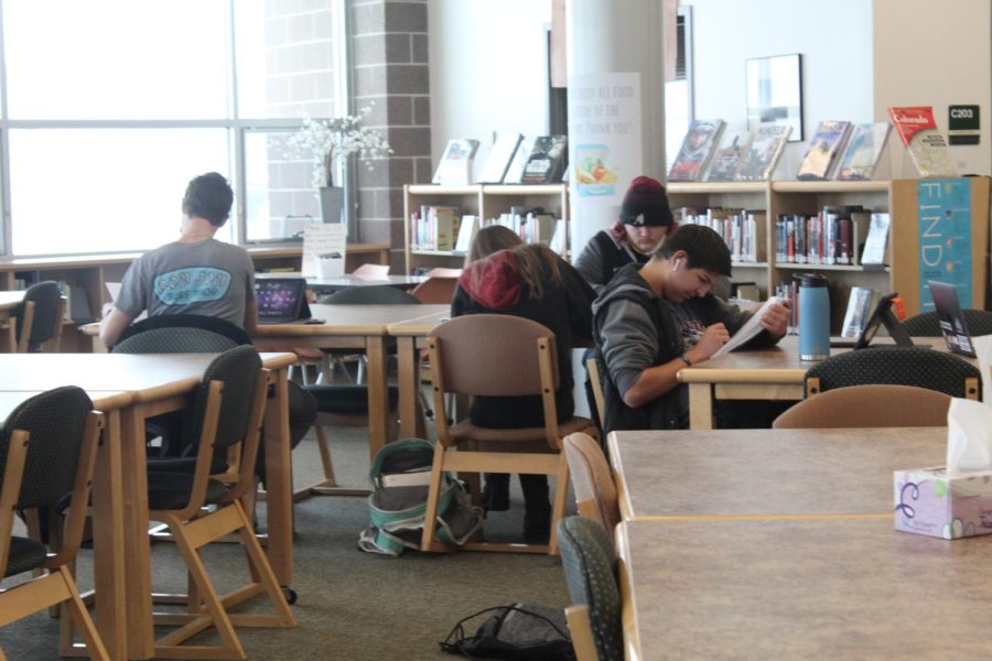 Students working and hanging out during their off block in the Mead library.