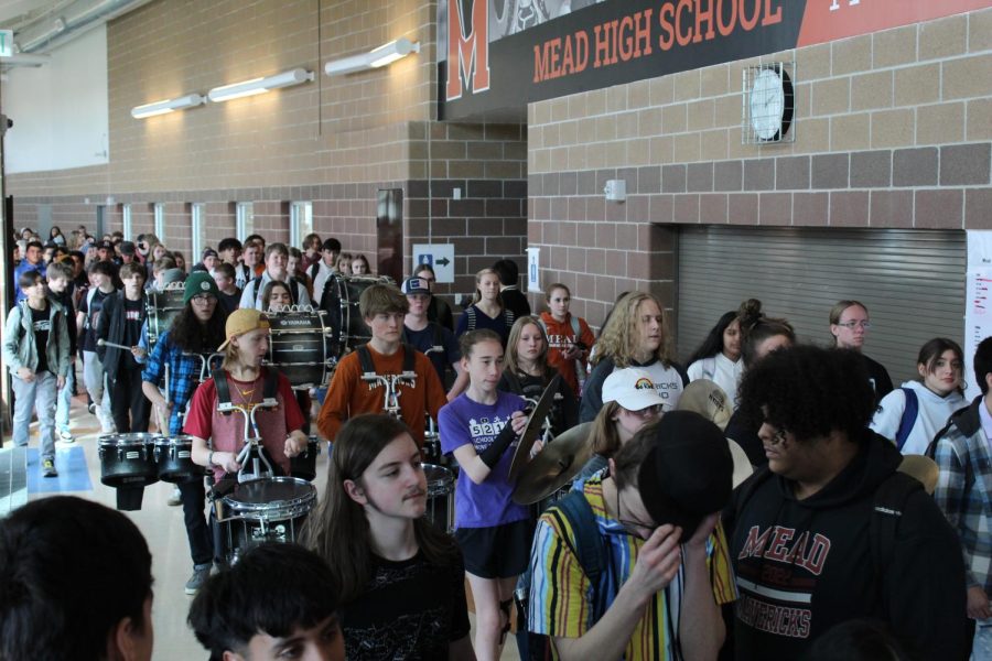 Students, including Mead’s drum line, head to the gym for the assembly.