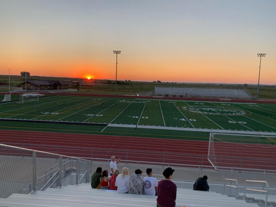 The Class of 2023 watches the sun rise.