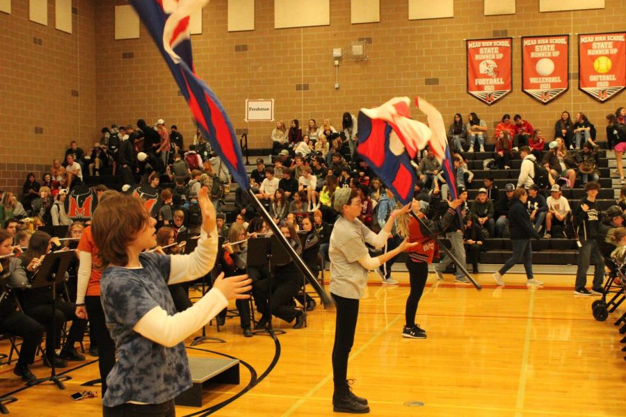 Color guard performs with the marching band at Mead Highs Veterans Day assembly  