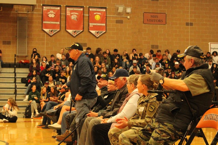Veterans share happy memories of their time serving during Veterans Day assembly.