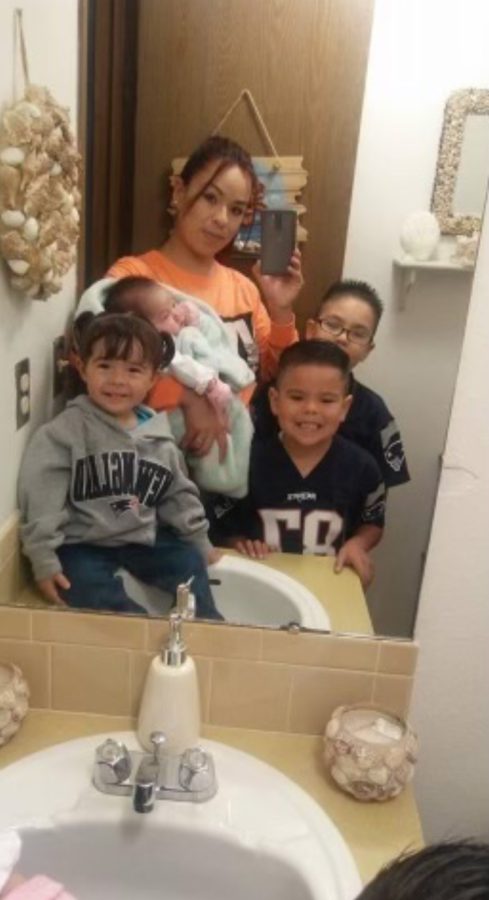 That’s me and my little brother on the right, my two younger sisters, and of course my mother. This photo was taken when we were getting ready to go see a Patriots game. Either way, we all look great.