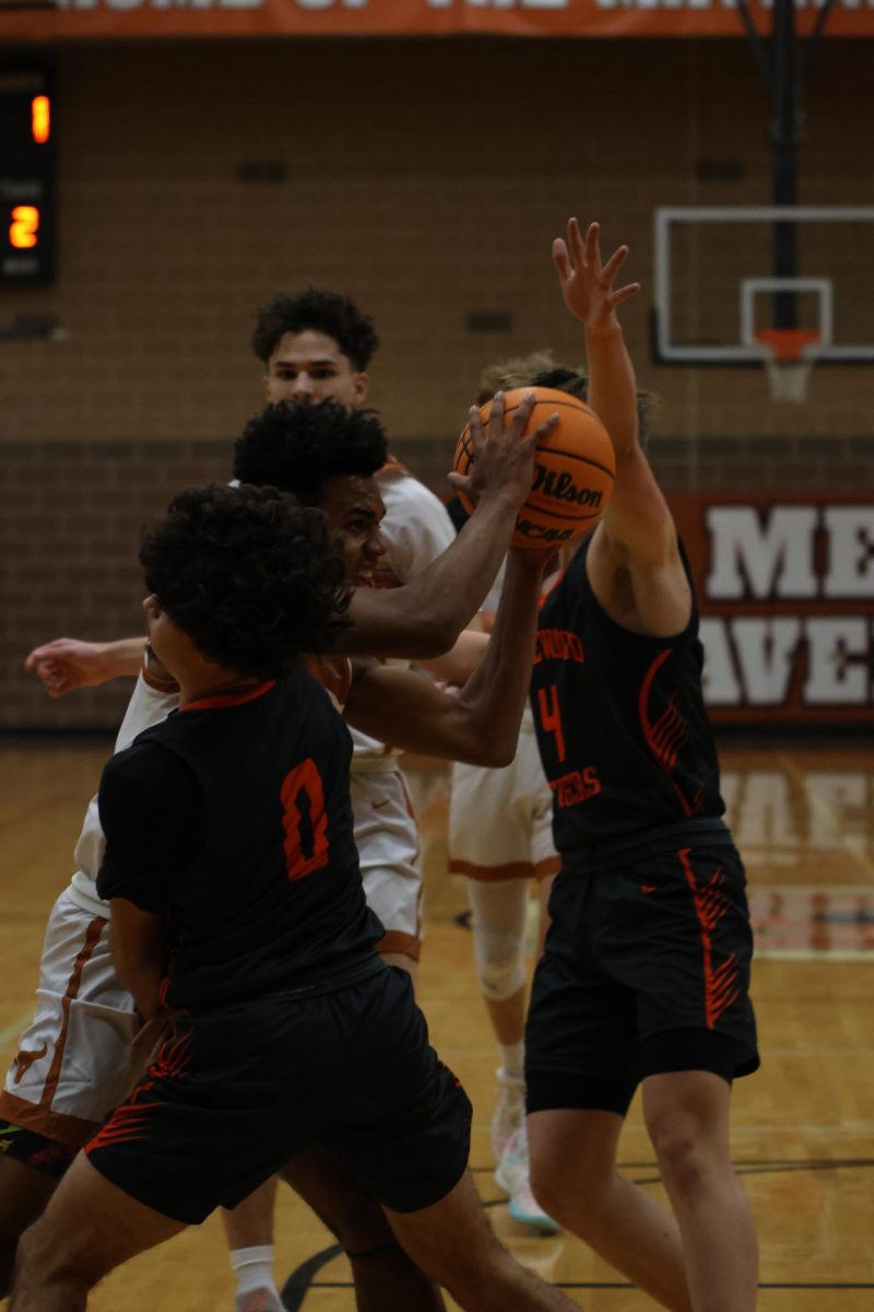 Dominic McLawrence (‘24) fights through contact through the lane in the game against Lakewood. The Mavs won the game 70-41 in quite the dominant performance. 