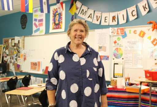 Ms. Freischlag smiles surrounded by her vibrant classroom.