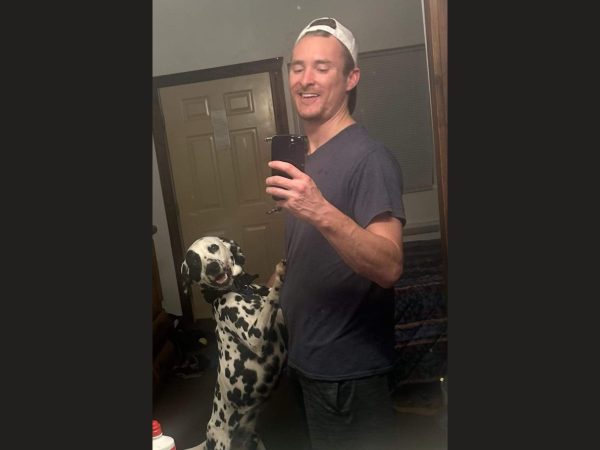 Nick Salvagni and his dog pose for a mirror photo.