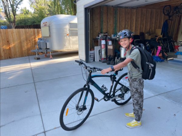 Liam pictured next to the bike he’d bought with his allowance
