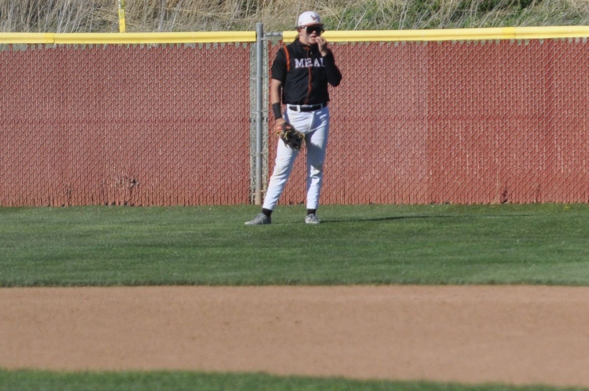 Dalton Berg (‘24) stands in the outfield waiting for some action.