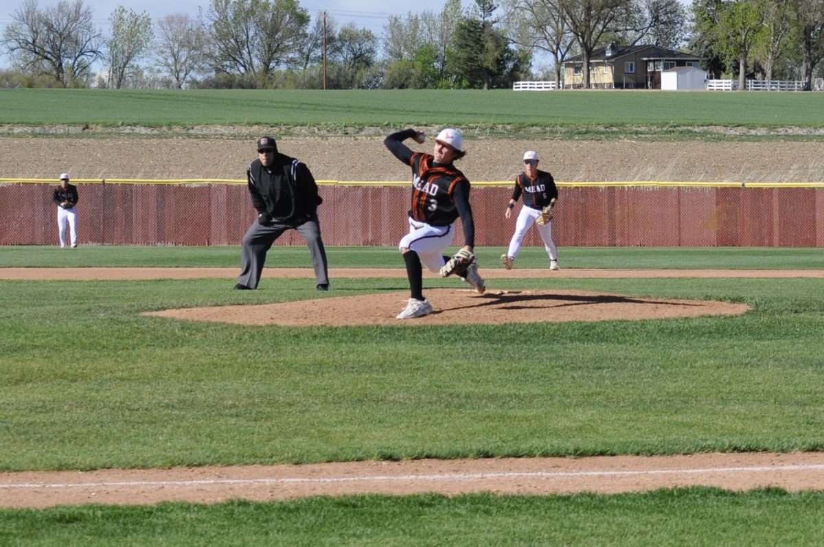 Edison Burke (‘25) in the middle of his pitching motion in the game against Fairview.