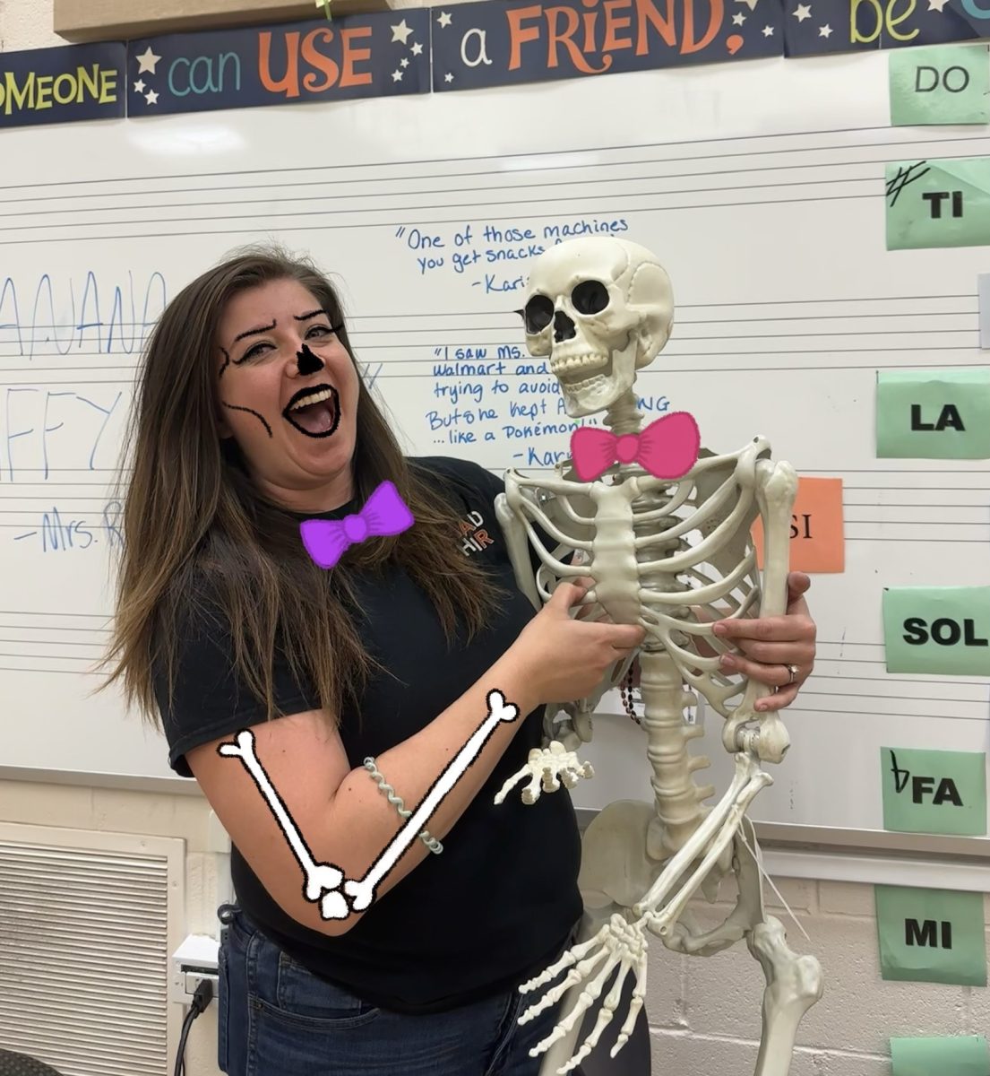 Ms. Berry poses with her iconic skeleton  (photo taken by Shayd Fuller)