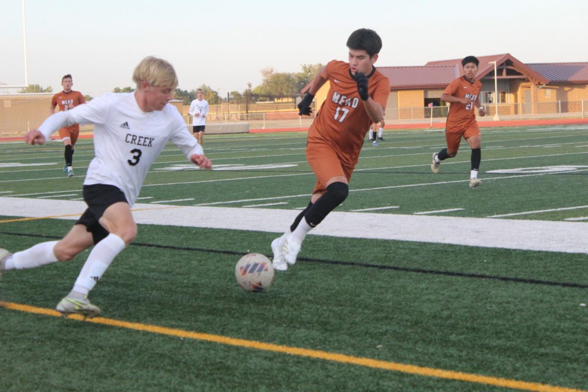 Devin Gonzalez (’25) attempts a tackle on Silver Creek forward Jack Boyt (’25).