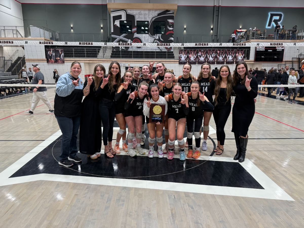 Mead’s volleyball team holds the state qualifying plaque after winning regionals at Roosevelt High School.