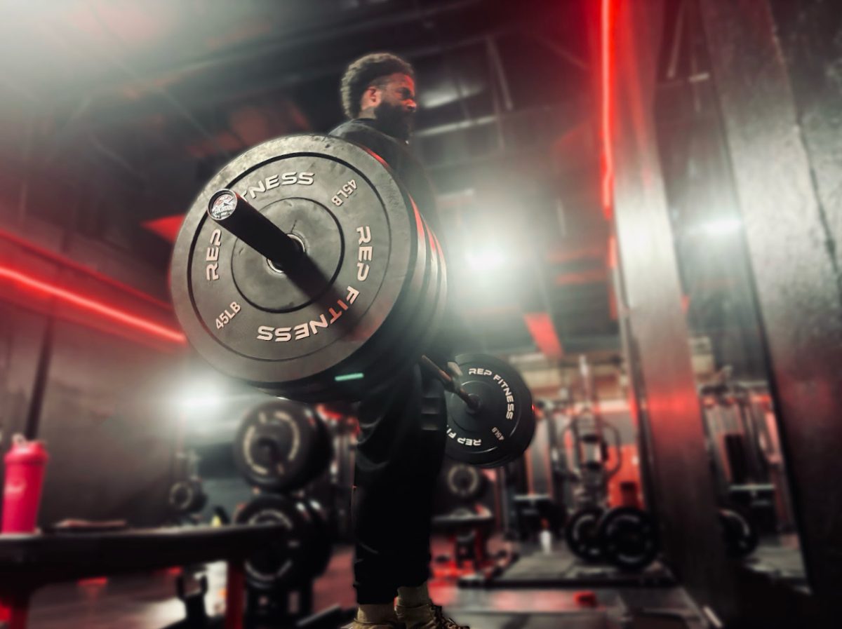 Robert completing a set of deadlifts, using three plates. 