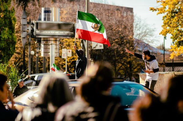 The Iranian Lion and Sword flag design is a symbol of opposition. Although it’s display is strictly banned, protesters wave it regardless. Photo courtesy of Tianli Wu on Unsplash.