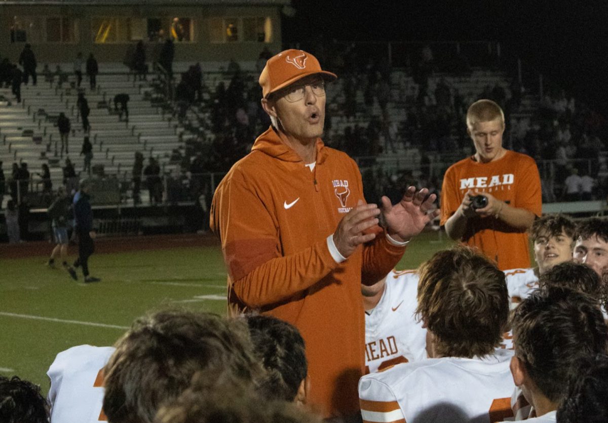 Coach Klatt speaks to his team after a football game.