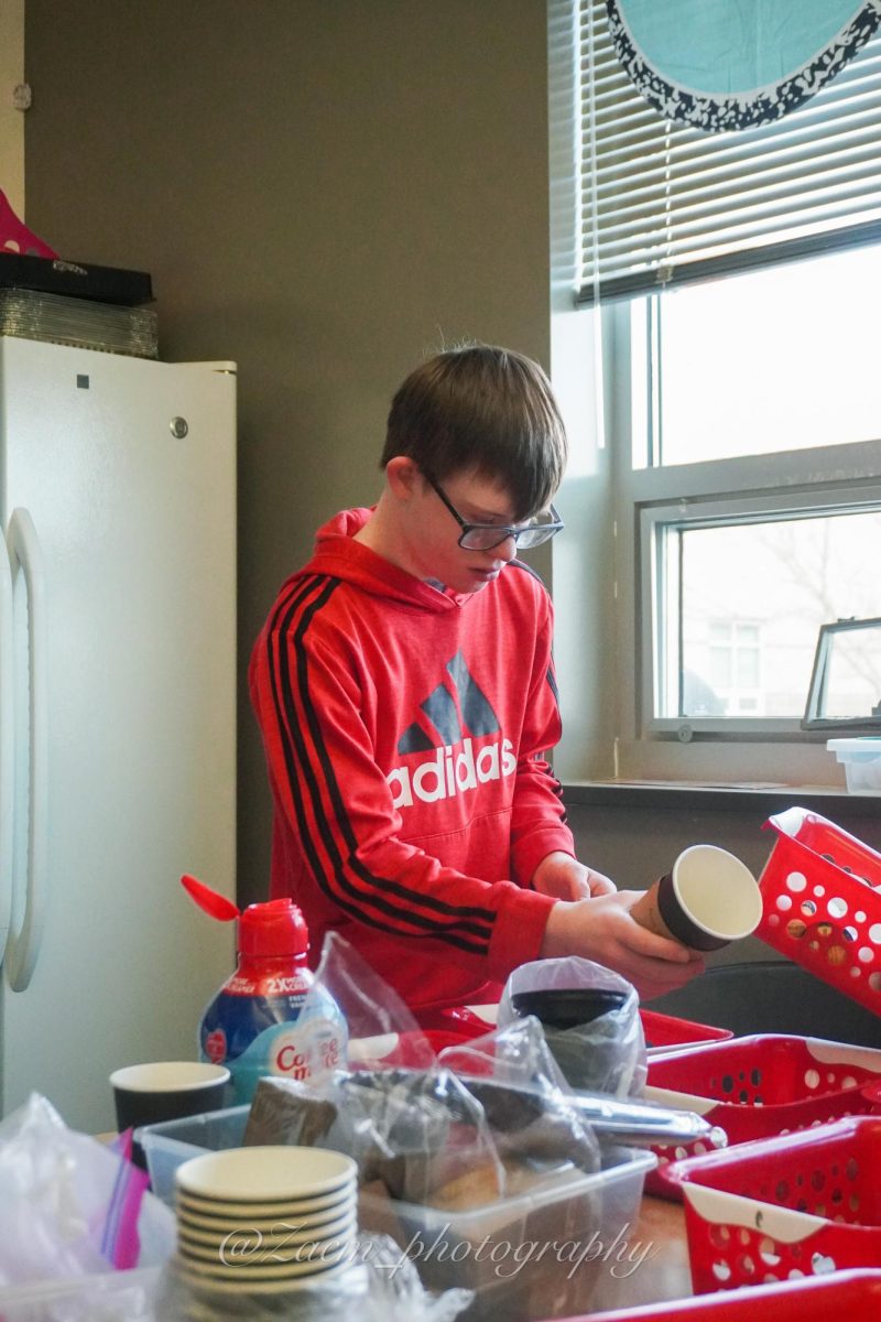 Caden Brooks ('29) prepares drinks ahead of time in the SSN classroom. 